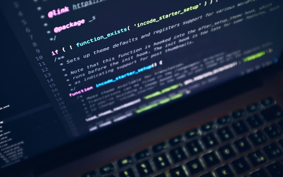 Analytics graphs on a laptop in a dark office