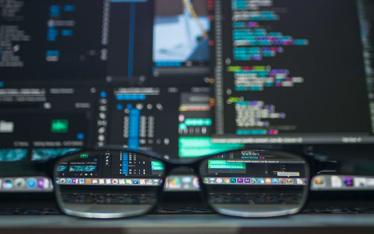 Analytics graphs on a laptop in a dark office