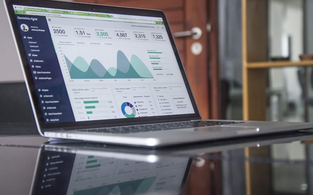 Theme code on a monitor during Shopify checkout extensibility work